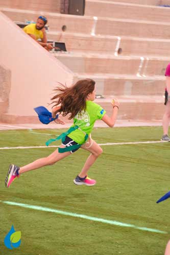 Egyptian girl running in flag football