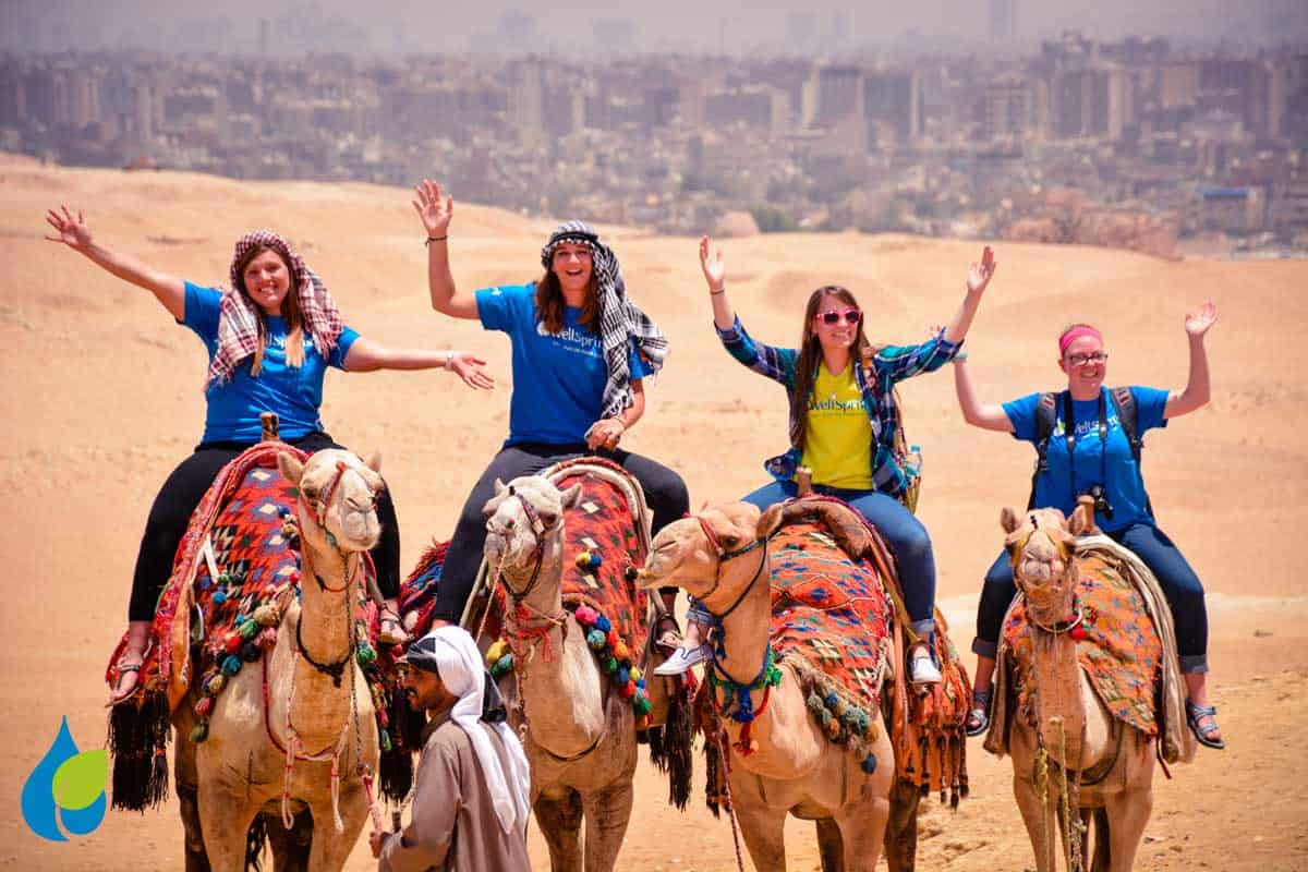 Cairn students riding camels
