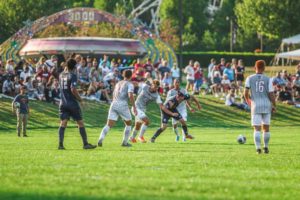 Men's soccer players compete in view of homecoming festivities
