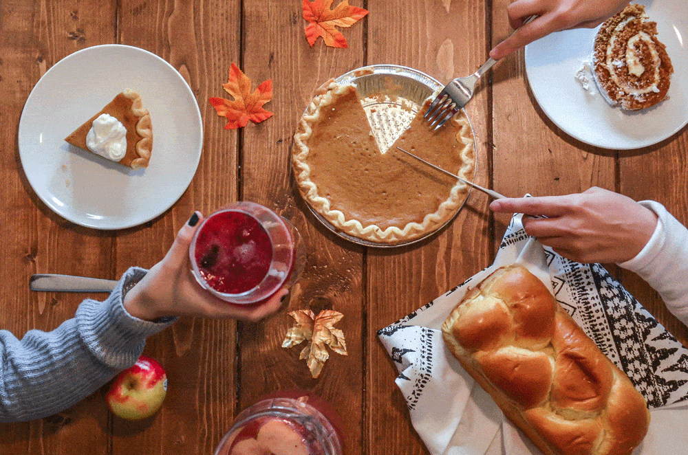 thanksgiving dinner table, hand serving pie