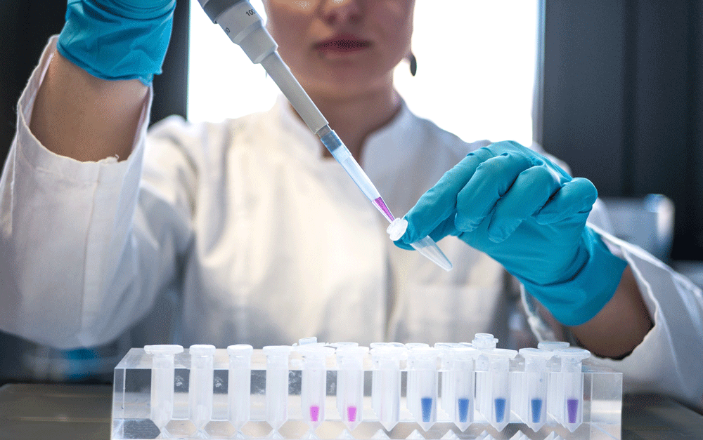 Woman in Lab with Test Tube web 1000