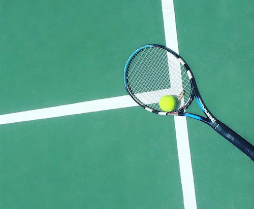 tennis racket and ball on court