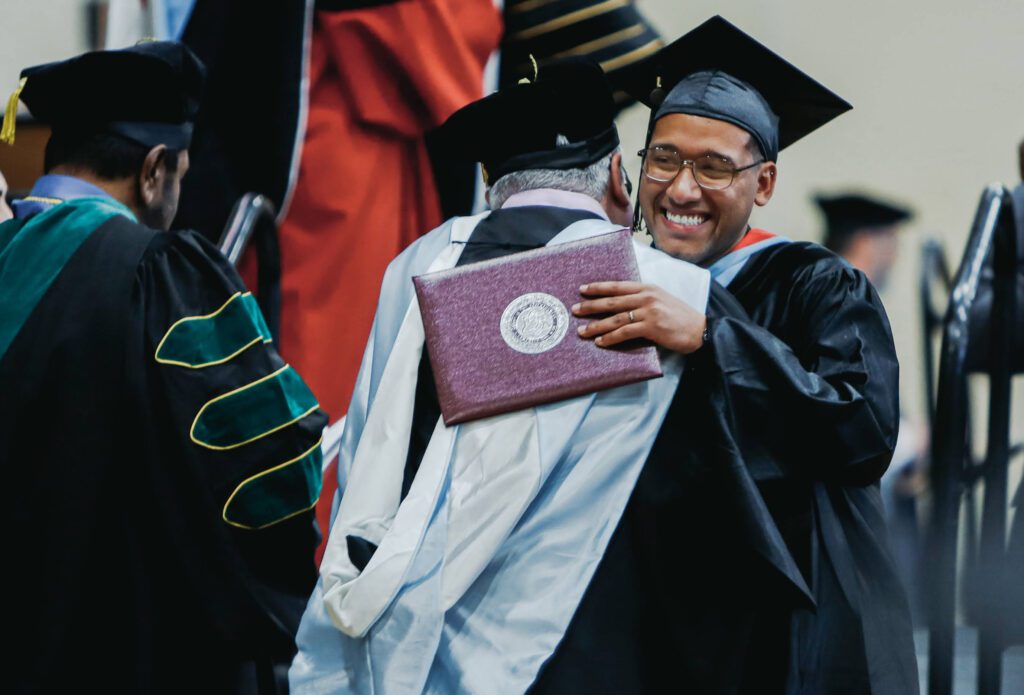A Cairn student receiving his degree at commencement.