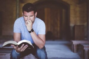 A picture of a student studying the Bible.