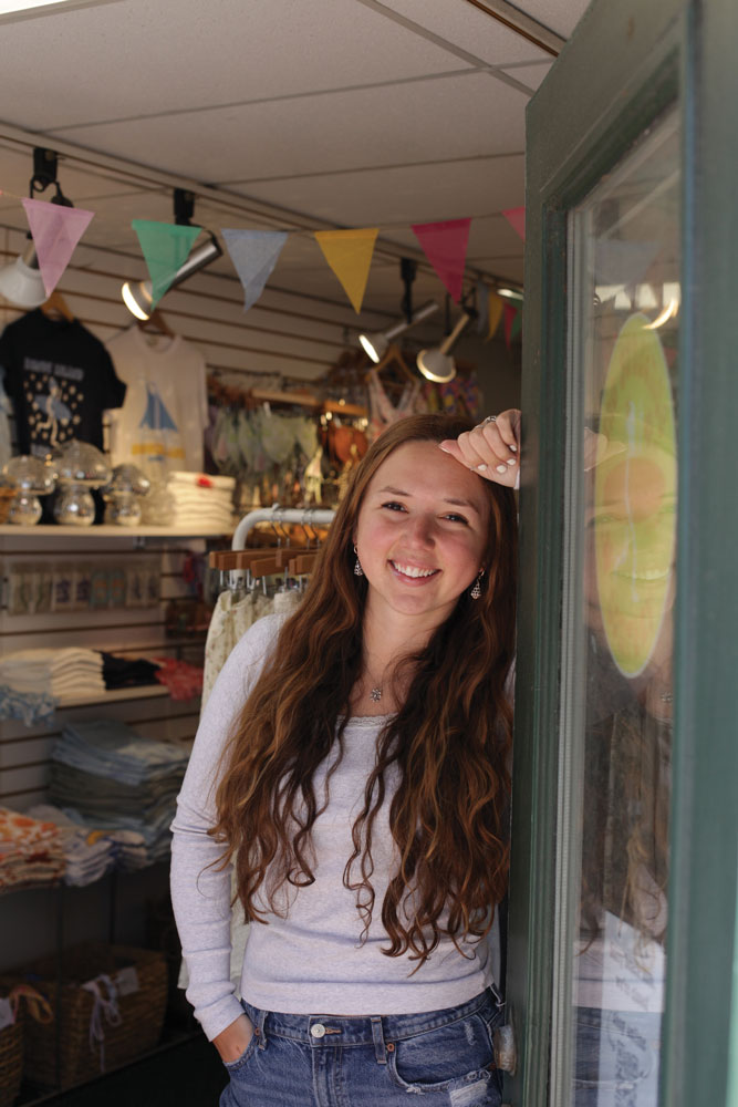 Abigail Edman poses for a photo in the doorway of The Sundance Company's retail space in Newport, RI.