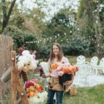 Katie Byler holding flowers at an outdoor event