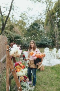 Katie Byler holding flowers at an outdoor event