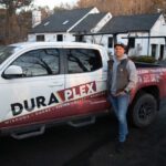 Ken Mercadante poses for a photo outside of a Dura-Plex work truck