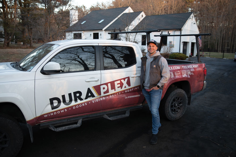 Ken Mercadante poses for a photo outside of a Dura-Plex work truck
