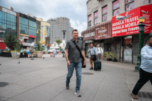 Kevin King walking through Diversity Plaza in NYC