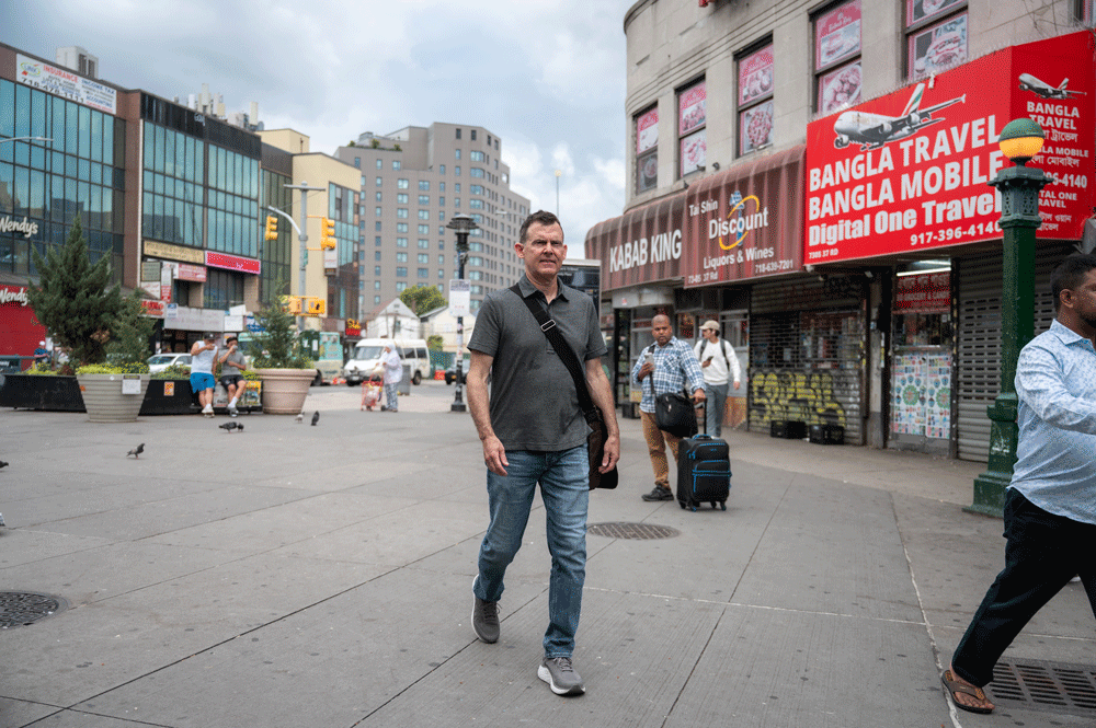 Kevin King walking through Diversity Plaza in NYC